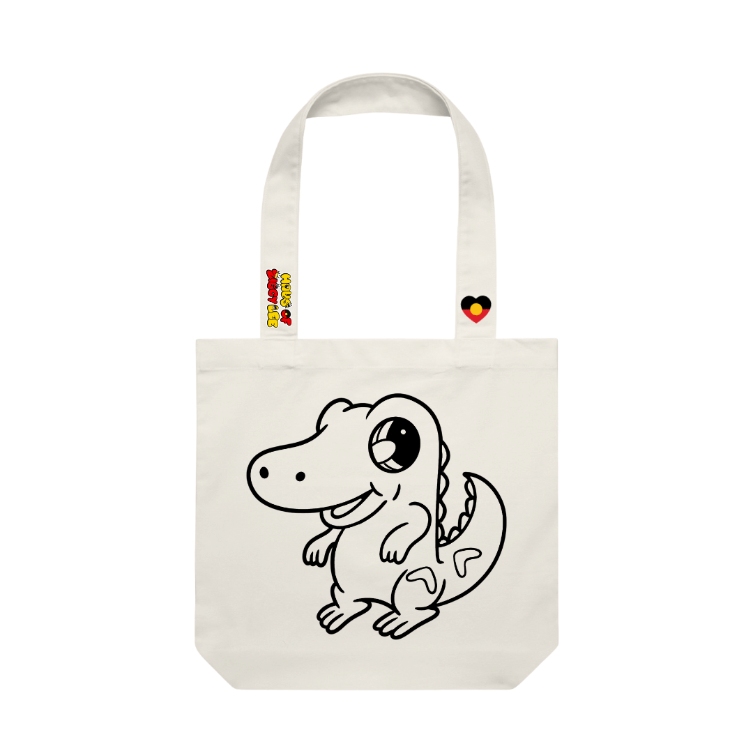 haus of ziggy lee canvas colour in tote bag with iluka cartoon crocodile design black outline to fill in. haus of ziggy lee logo and aboriginal flag heart decals on strap.