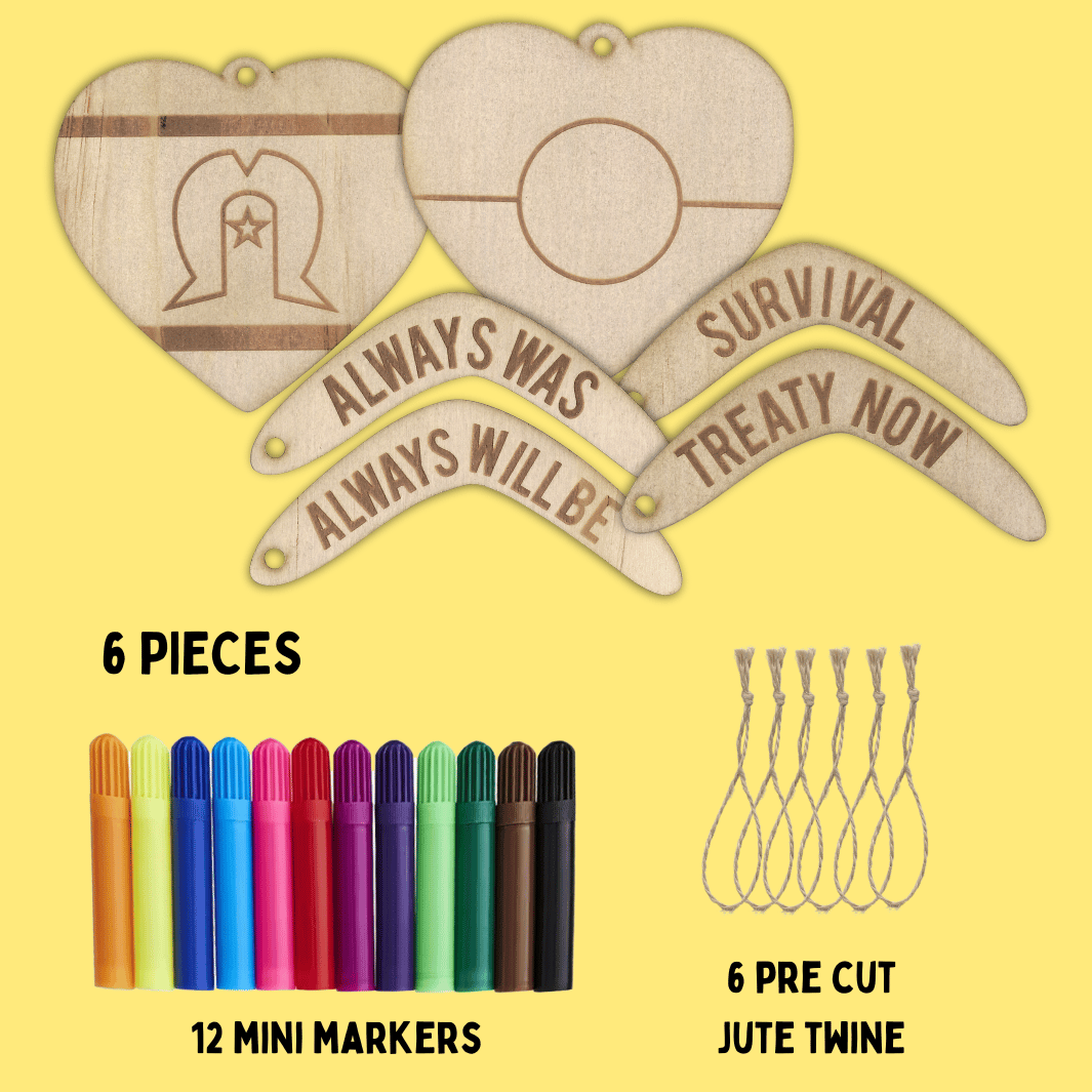 set of haus of ziggy lee wooden heart-shaped ornaments and boomerang shaped ornaments with engraved text, markers, and jute twine on a yellow background