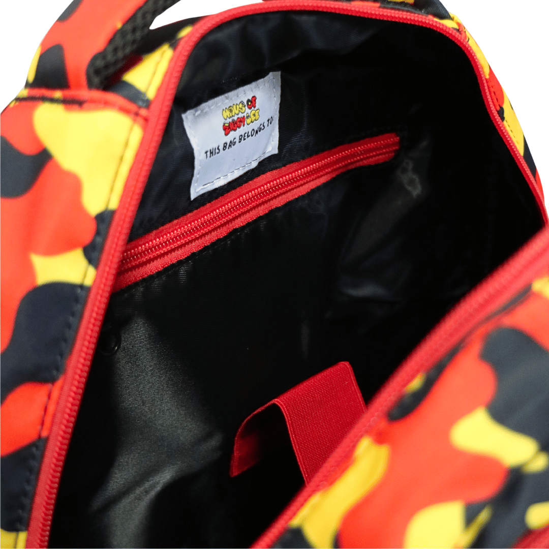 Close-up of haus of ziggy lee everyday deadly backpack with a black interior lining and a white embroidered label reading 'This Bag Belongs To'.