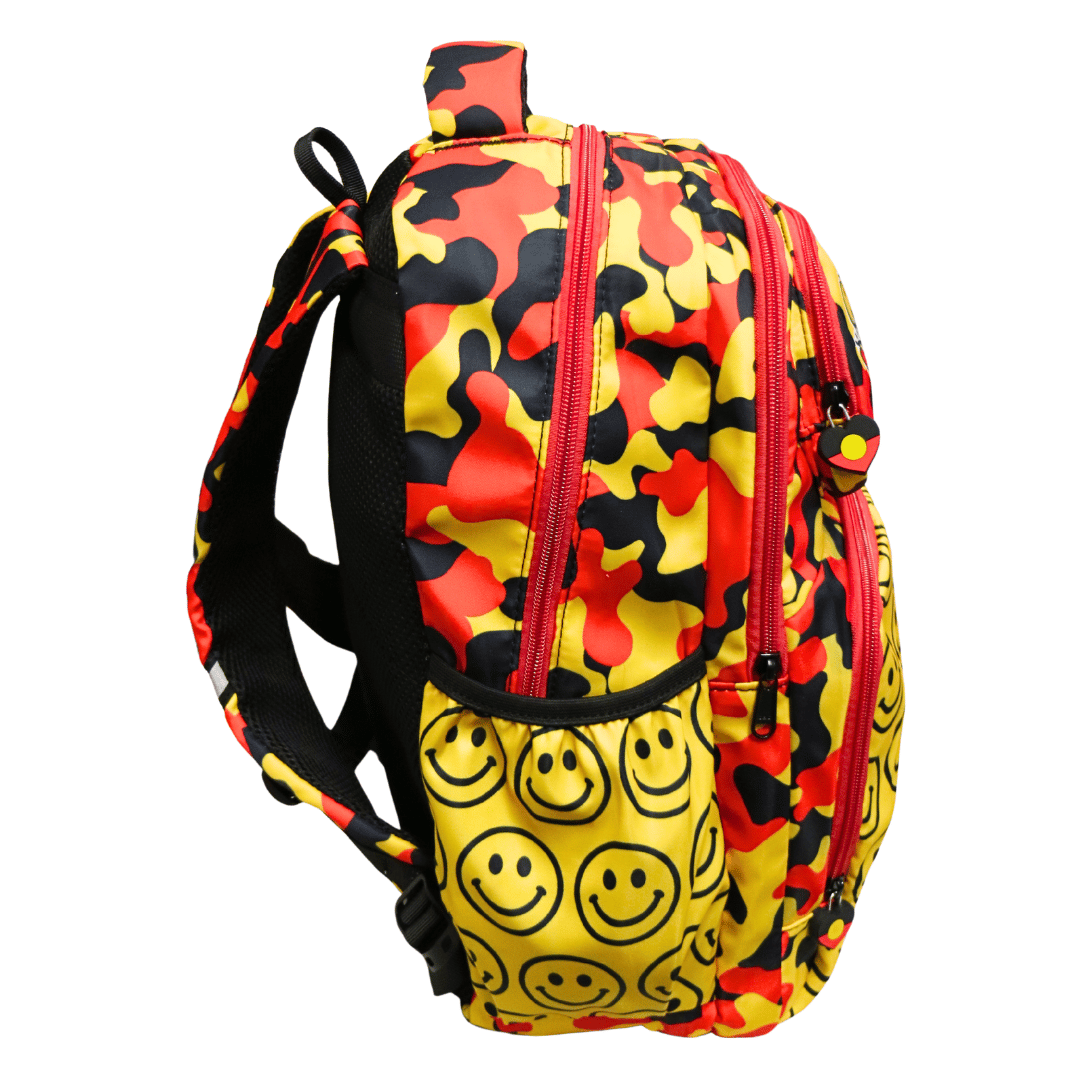 black, yellow, and red camouflage backpack with a large yellow front pocket covered in black smiley faces, featuring custom pvc zipper pull with the Aboriginal flag in a heart shape - side view