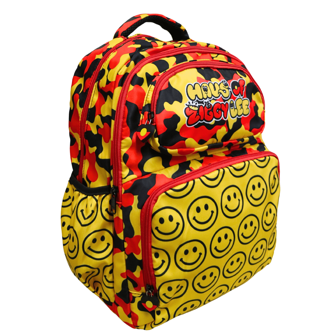 black, yellow, and red camouflage backpack with a large yellow front pocket covered in black smiley faces, featuring the 'Haus of Ziggy Lee' logo on the top compartment - second front view